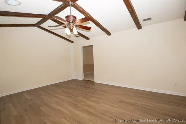 a view of an empty room with fire place and a fireplace