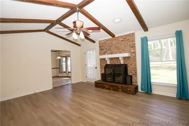 a bathroom with a shower a toilet and a window