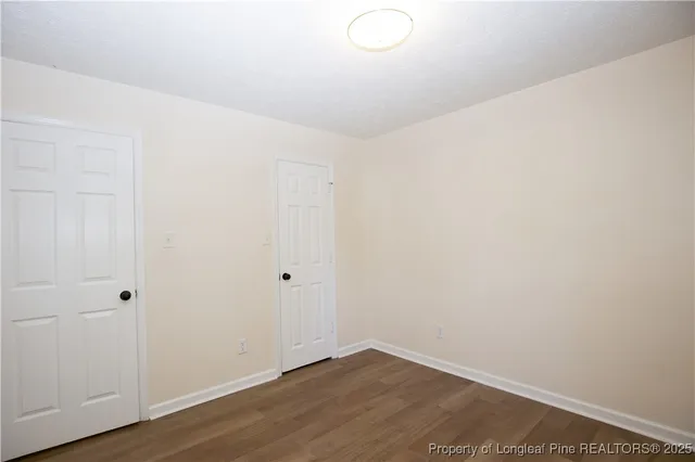 a view of a room with wooden floor and a ceiling fan
