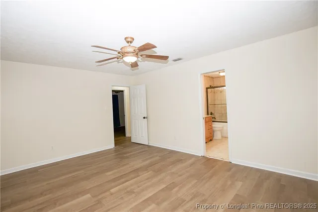 a view of a room with wooden floor