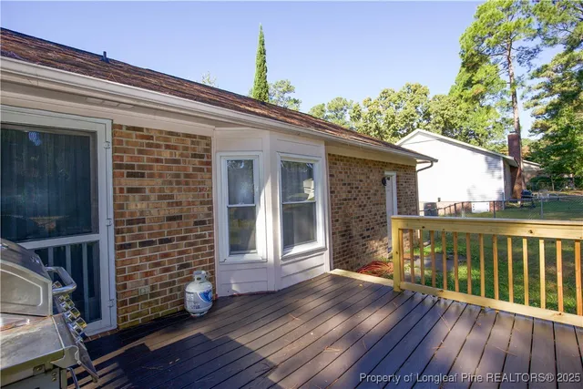 a view of a balcony with wooden floor and outdoor space