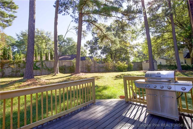 a view of a house with a yard and basketball court