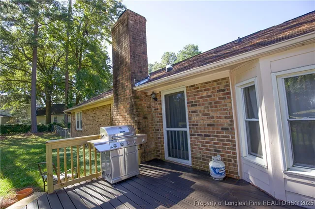 a view of a house with a yard and a tree