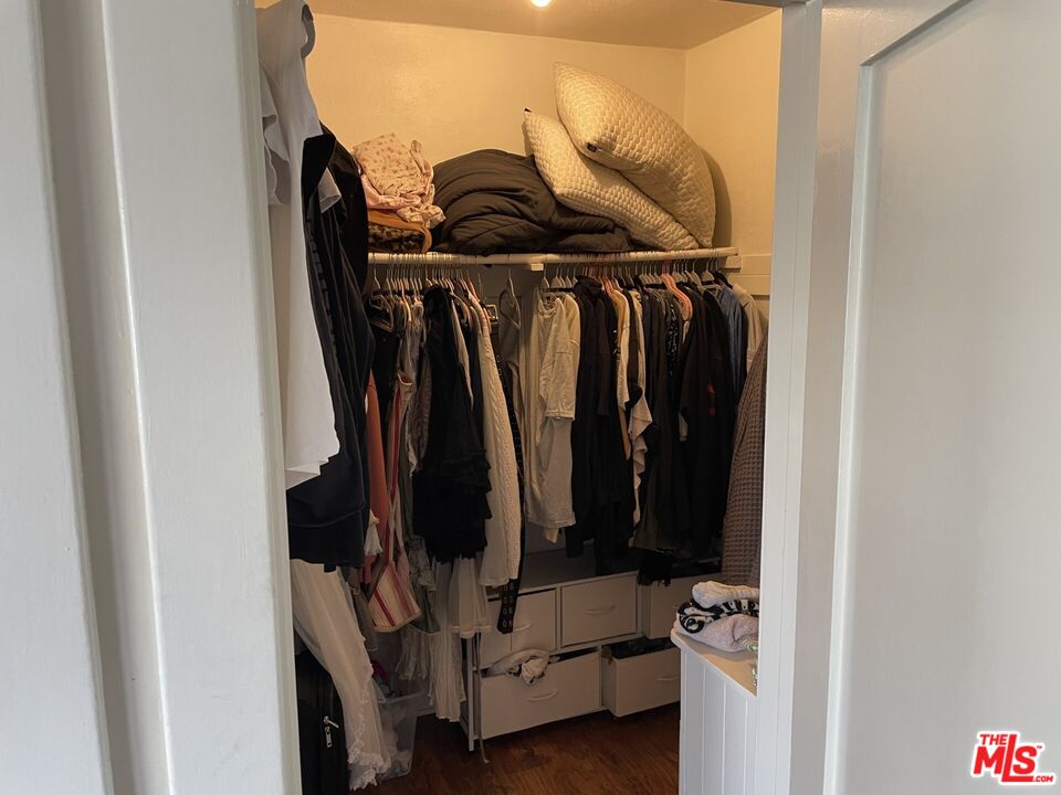1920 South Rimpau Boulevard Los Angeles, CA 90016 - Photo 11 of 25 a view of walk in closet with clothes and shoes