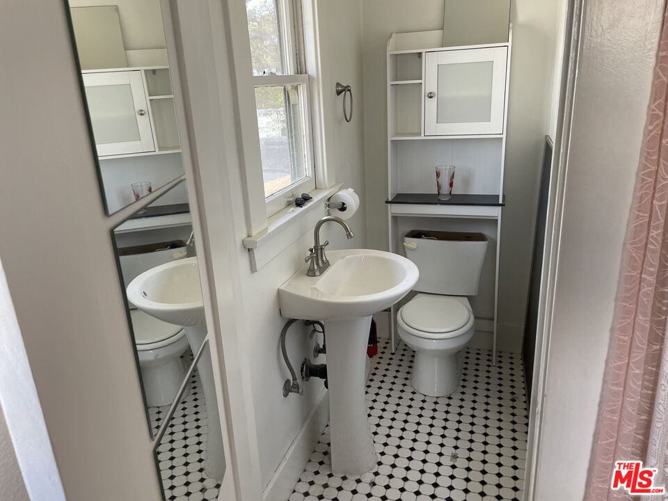 1920 South Rimpau Boulevard Los Angeles, CA 90016 - Photo 13 of 25 a bathroom with a sink toilet and shower