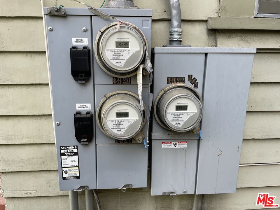 1920 South Rimpau Boulevard Los Angeles, CA 90016 - Photo 24 of 25 a and white kitchen with stainless steel appliances