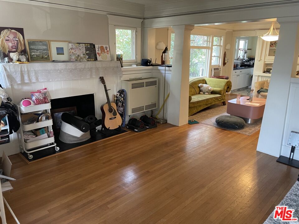 1920 South Rimpau Boulevard Los Angeles, CA 90016 - Photo 3 of 25 a living room with furniture and a fireplace
