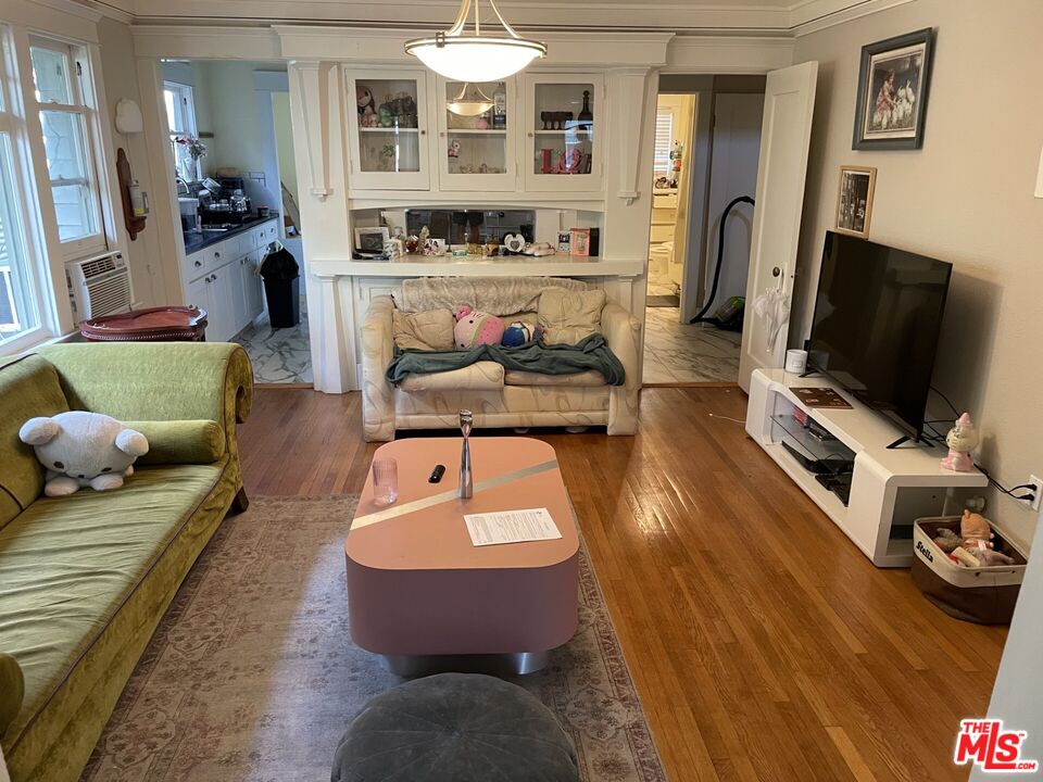 1920 South Rimpau Boulevard Los Angeles, CA 90016 - Photo 4 of 25 a living room with furniture and a flat screen tv