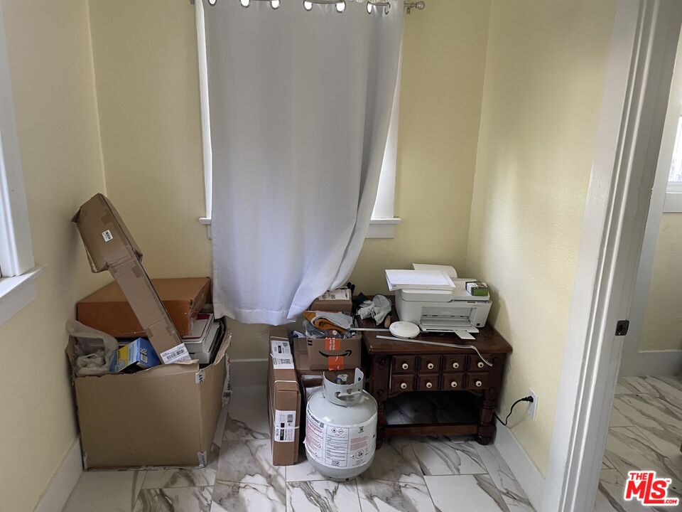 1920 South Rimpau Boulevard Los Angeles, CA 90016 - Photo 6 of 25 a living room with furniture and a chandelier