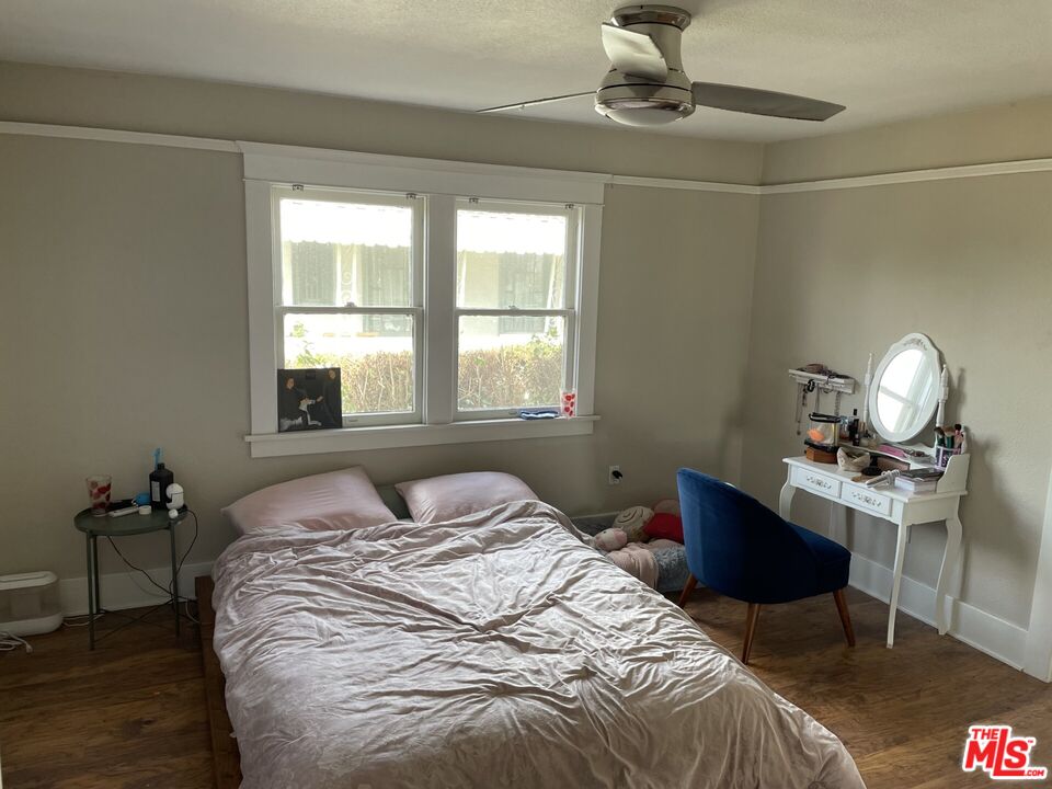 1920 South Rimpau Boulevard Los Angeles, CA 90016 - Photo 10 of 25 a bedroom with a bed window and a desk