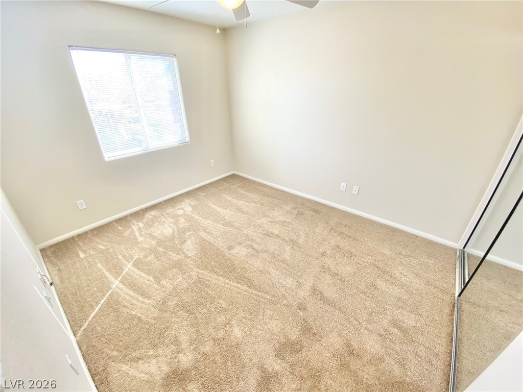 8569 Rhamus Court Las Vegas, NV 89149 - Photo 17 of 35 A spacious, naturally illuminated room featuring warm carpeting and a generous window.
