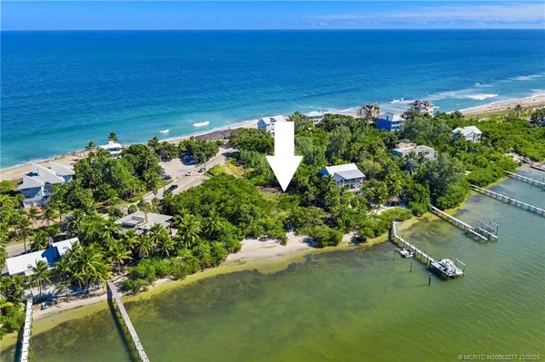 a view of a dirt road with trees in the background