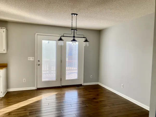 a view of a room with wooden floor and window