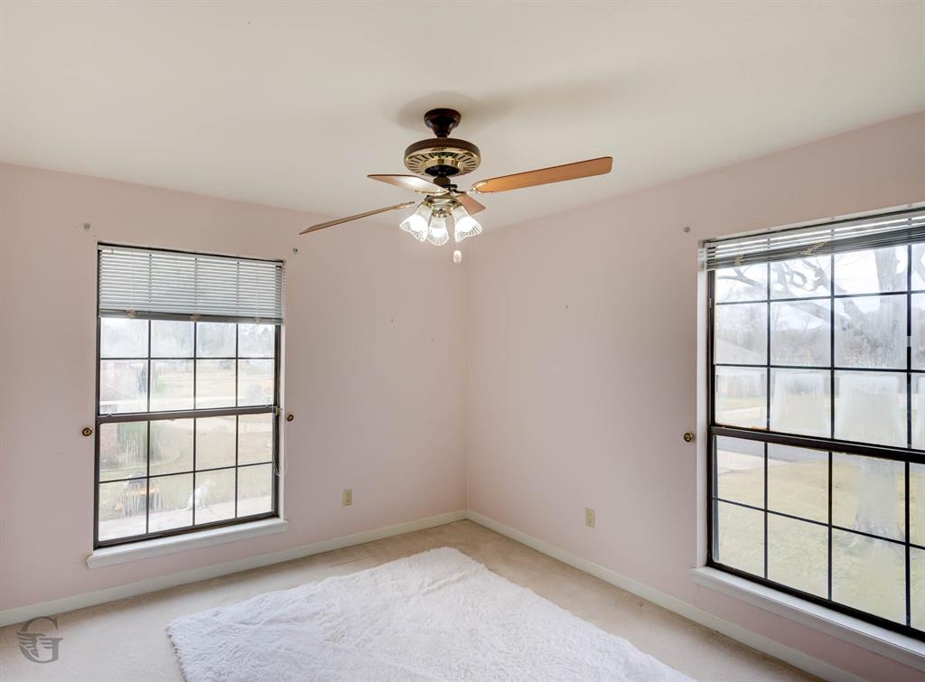 5516 Hickory Ridge Drive Bossier City, LA 71111 - Photo 27 of 33 an empty room with chandelier fan and windows
