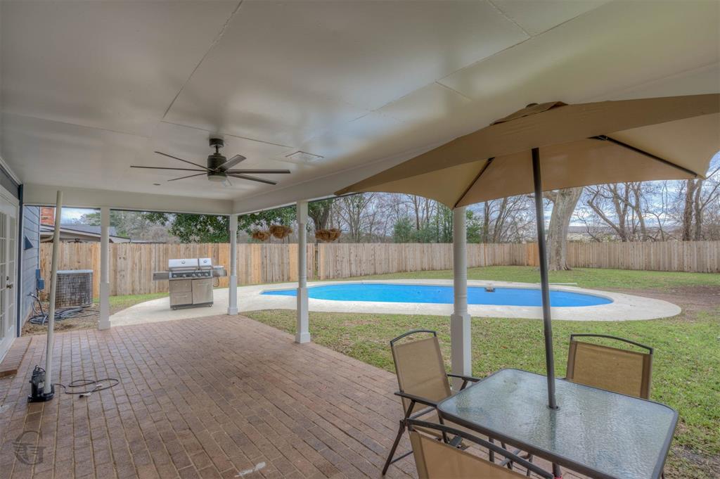 5516 Hickory Ridge Drive Bossier City, LA 71111 - Photo 32 of 33 a view of a swimming pool with a table and chairs
