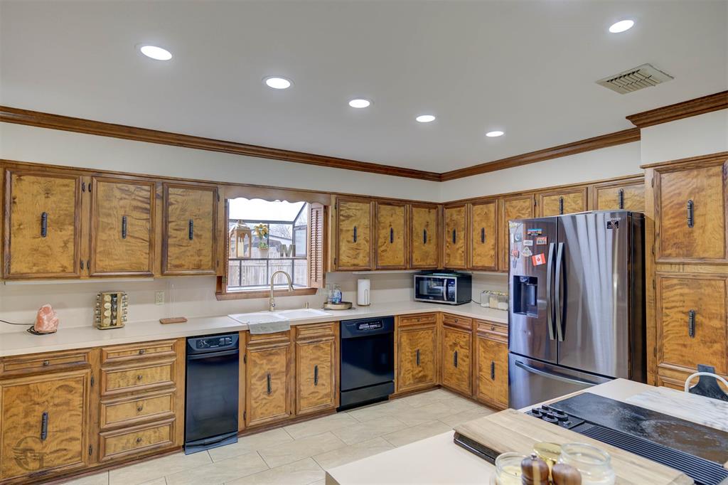 5516 Hickory Ridge Drive Bossier City, LA 71111 - Photo 10 of 33 a kitchen with granite countertop a sink stainless steel appliances and cabinets
