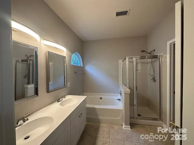 a bathroom with a granite countertop sink mirror bathtub and shower