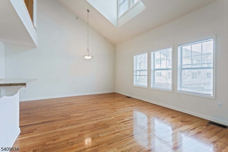 31 Magnolia Terrace Springfield, NJ 07081 - Photo 2 of 5 a view of an empty room with wooden floor and a window