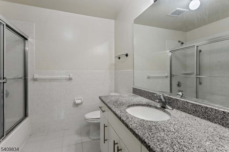 31 Magnolia Terrace Springfield, NJ 07081 - Photo 4 of 5 a bathroom with a granite countertop sink toilet and shower