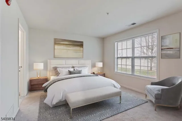 a bedroom with a bed and a couch with window