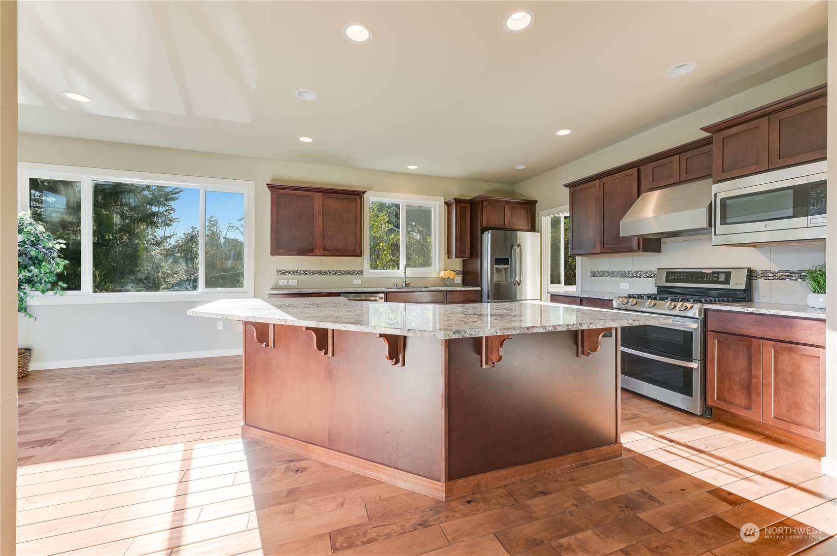 10408 Southeast 13th Street Bellevue, WA 98004 - Photo 10 of 38 a kitchen with stainless steel appliances granite countertop a stove a sink and a microwave