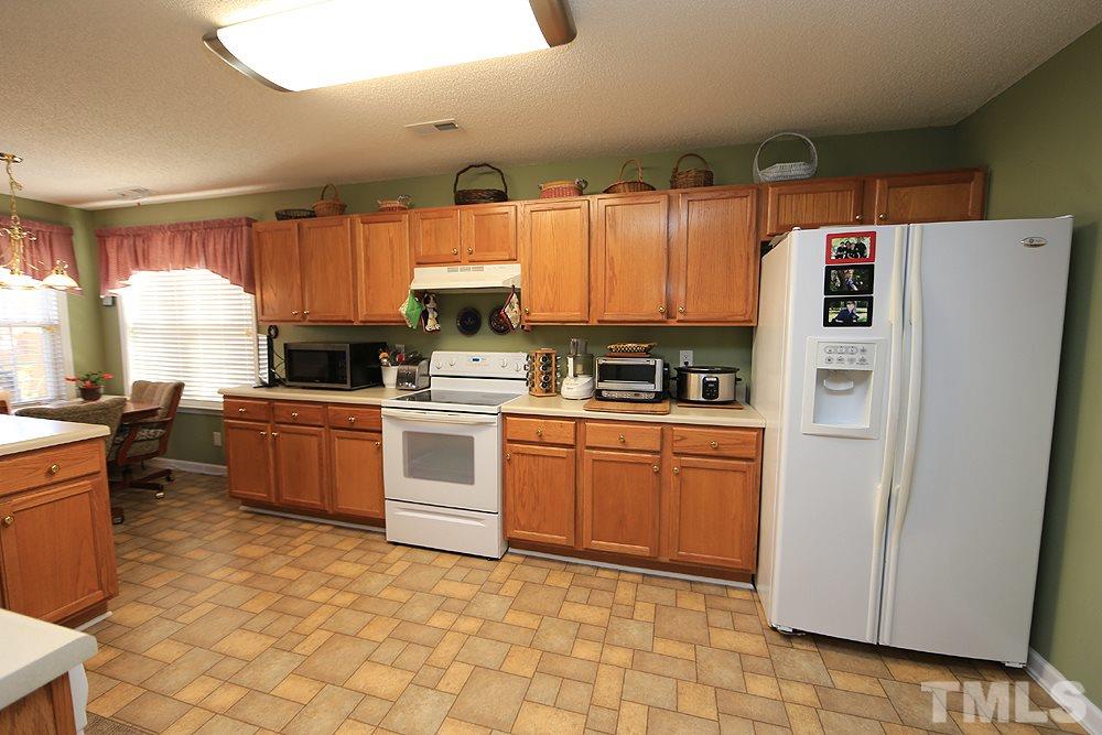 4707 Drewbridge Way Raleigh, NC 27604 - Photo 14 of 28 a kitchen with stainless steel appliances a refrigerator sink and microwave
