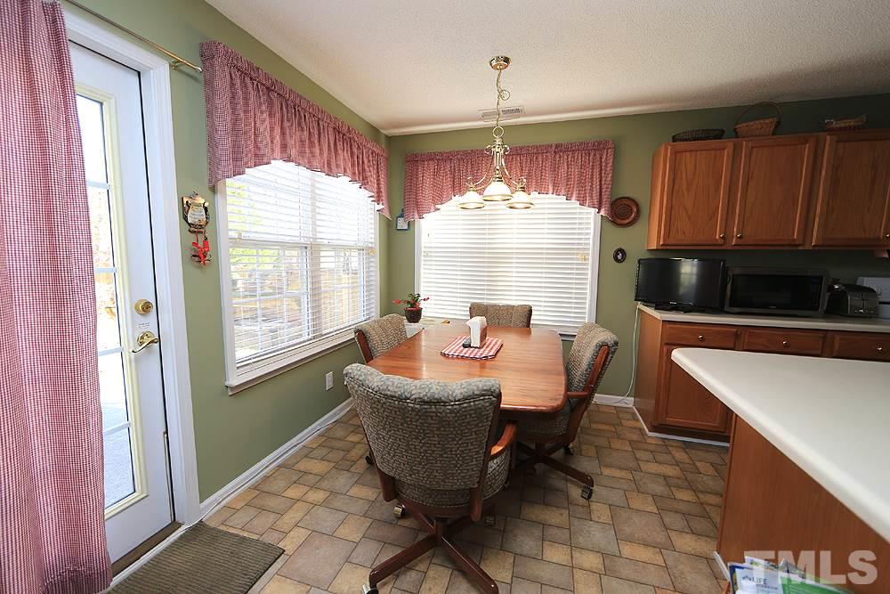 4707 Drewbridge Way Raleigh, NC 27604 - Photo 15 of 28 a dining room with furniture and window