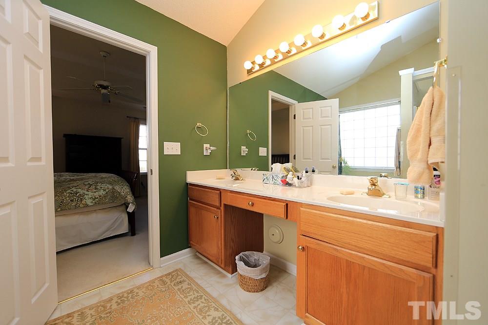 4707 Drewbridge Way Raleigh, NC 27604 - Photo 18 of 28 a en suite bathroom with a sink and a mirror
