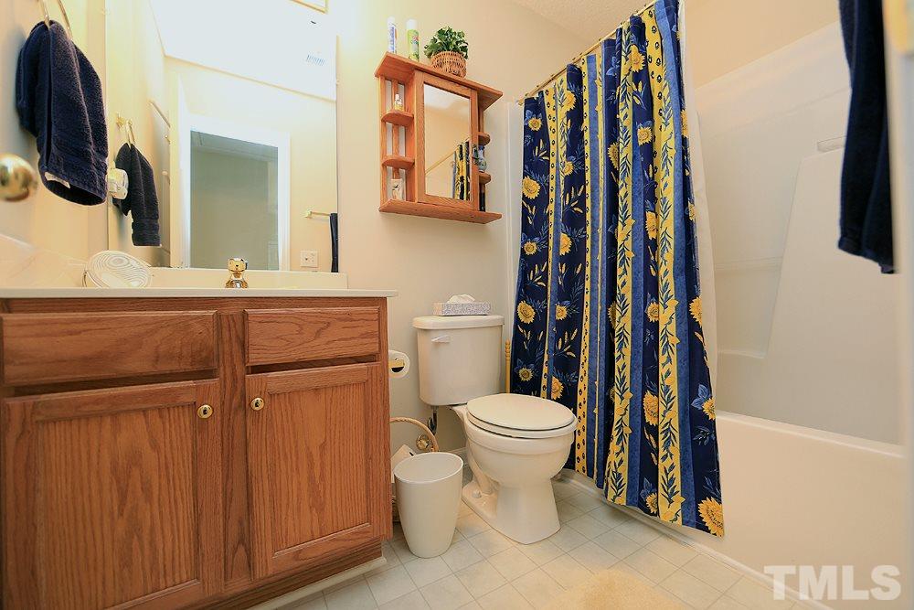 4707 Drewbridge Way Raleigh, NC 27604 - Photo 23 of 28 a bathroom with a toilet and a sink