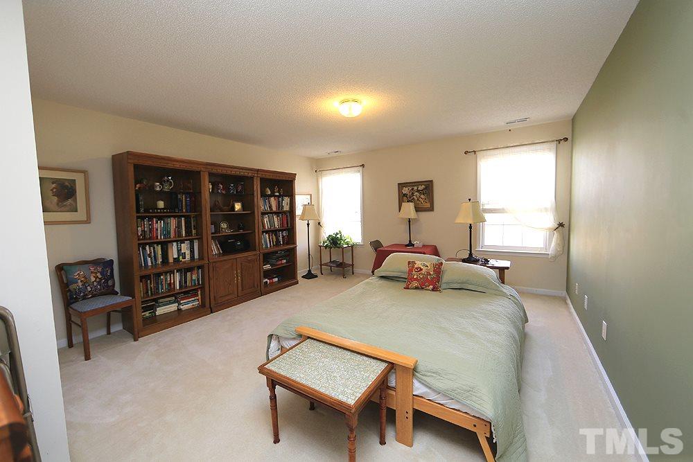 4707 Drewbridge Way Raleigh, NC 27604 - Photo 24 of 28 a bed room with a bed and a large window