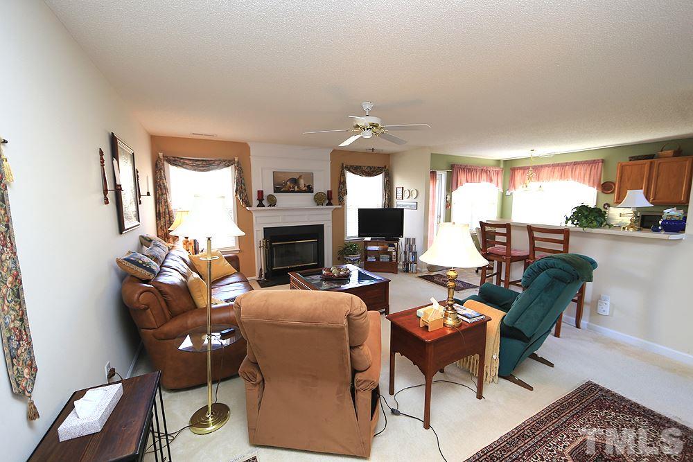 4707 Drewbridge Way Raleigh, NC 27604 - Photo 8 of 28 a living room with fireplace furniture and a fireplace