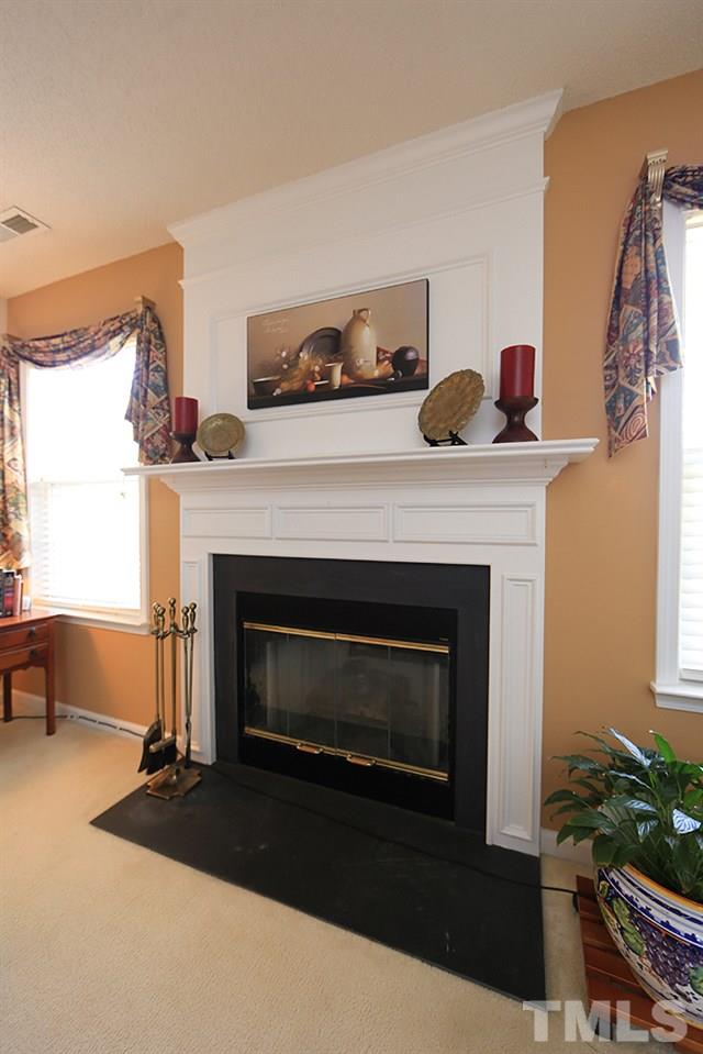 4707 Drewbridge Way Raleigh, NC 27604 - Photo 9 of 28 a living room with furniture and a fireplace