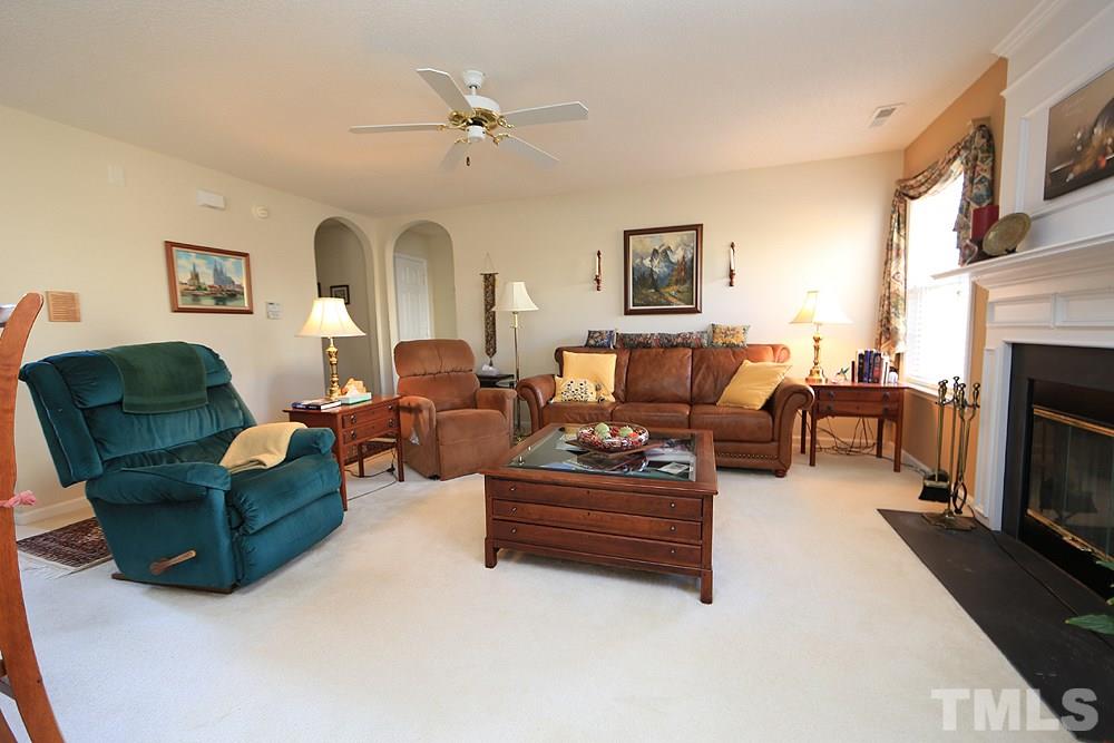 4707 Drewbridge Way Raleigh, NC 27604 - Photo 10 of 28 a living room with furniture fireplace and a flat screen tv