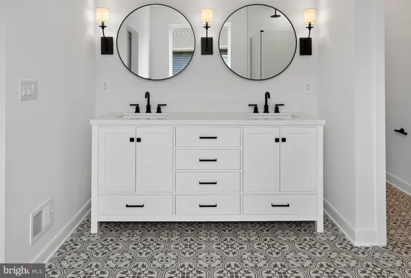 a bathroom with a double vanity sink mirror and