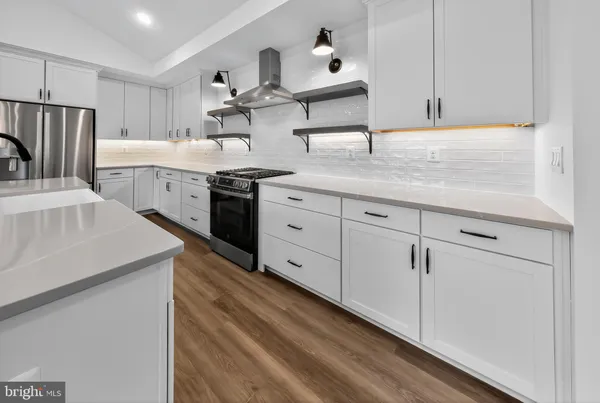 a kitchen with stainless steel appliances a sink stove and refrigerator