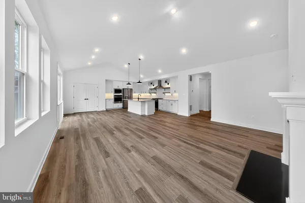 a view of kitchen with wooden floor and electronic appliances
