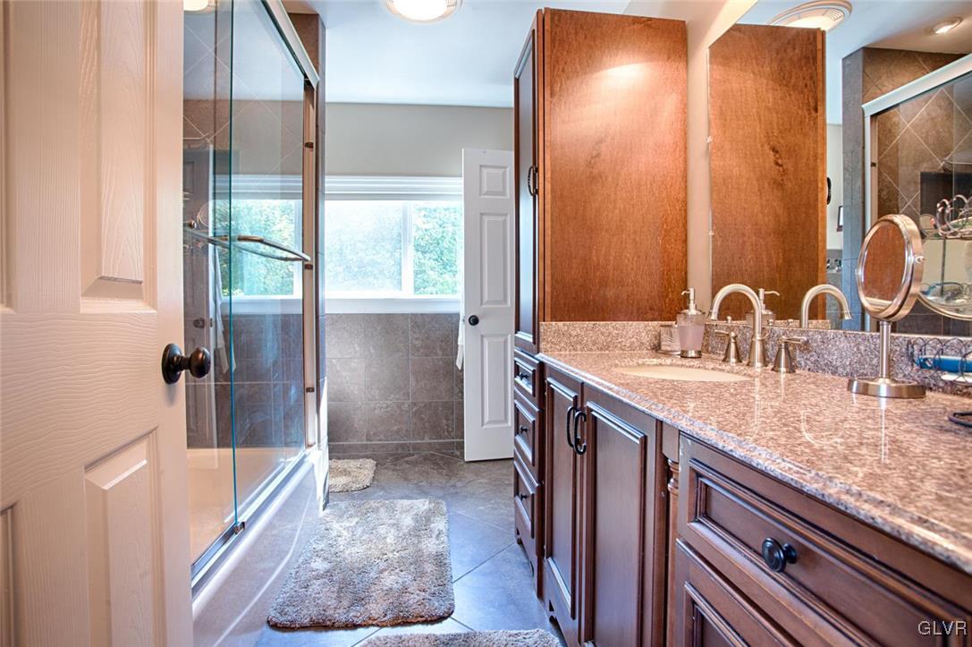 873 Gove Road Nazareth, PA 18064 - Photo 13 of 40 a bathroom with a sink a tub and a mirror