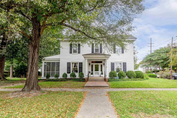 a front view of a house with garden