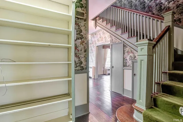 wooden floor fireplace and windows in an empty room with a fireplace