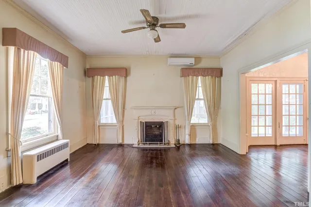 wooden floor in an empty room with a window