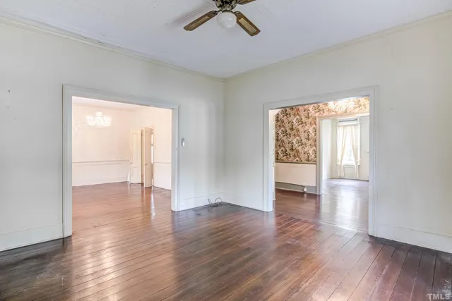 wooden floor in an empty room with a window