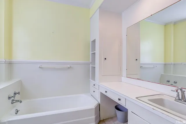 a utility room with a sink and cabinets