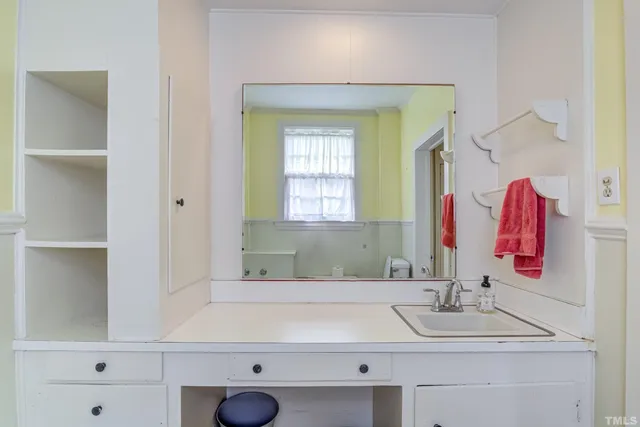 a kitchen with granite countertop a sink stove and cabinets