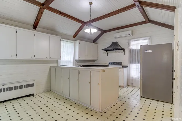 a kitchen with a stove a sink and a refrigerator