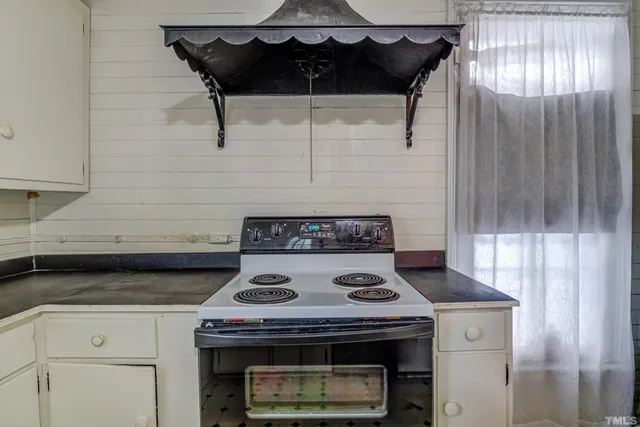 a kitchen with stainless steel appliances a stove a sink a microwave and cabinets