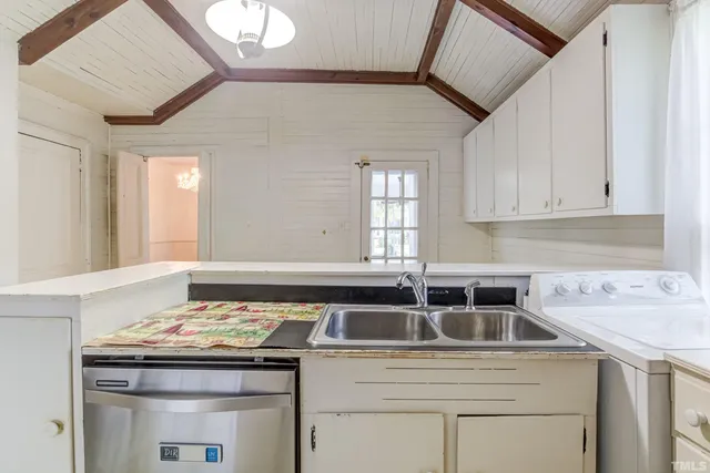 a kitchen with cabinets appliances and a center island