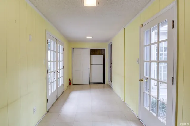 a front view of a house with a yard and green space