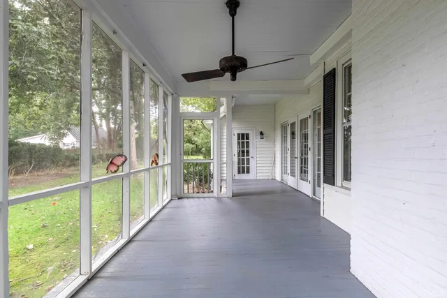 a aerial view of a house with swimming pool and large trees