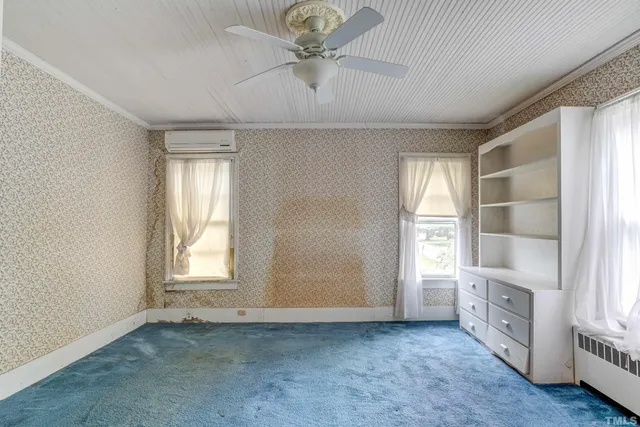 an aerial view of a house with a yard and garden