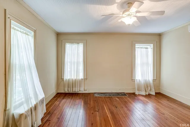 an aerial view of residential houses with outdoor space and trees